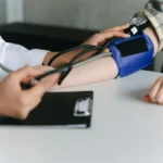 Photo of a Nurse checking a patient's blood pressure.