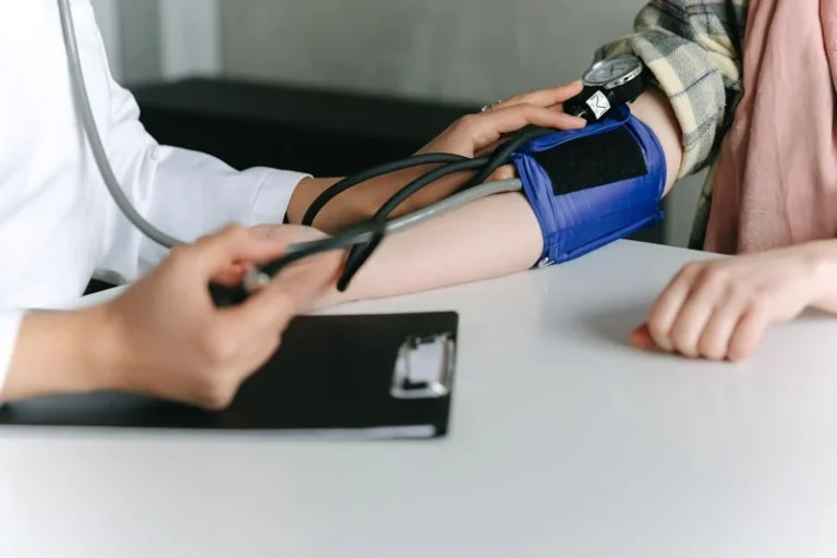 Practical Steps to Lower your Blood Pressure Photo of a Nurse checking a patient's blood pressure.