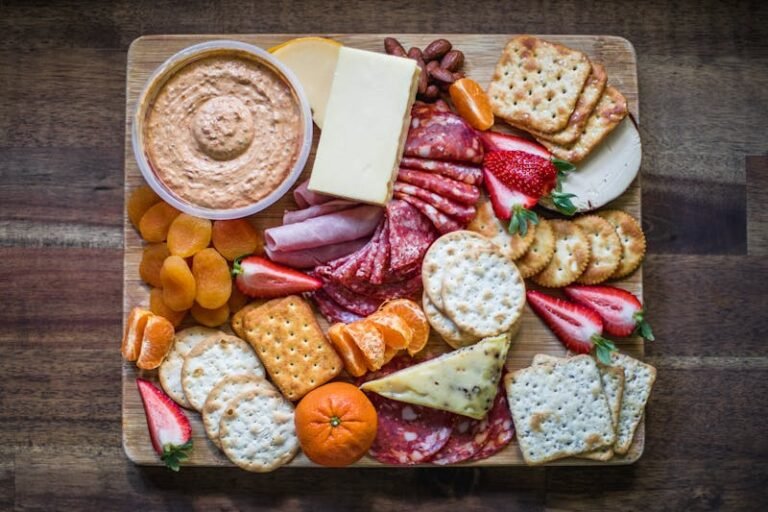 Healthy Snacking Is Possible Photo of Healthy Snack options, such as crackers and hummus, cheese, meat, and fruit.